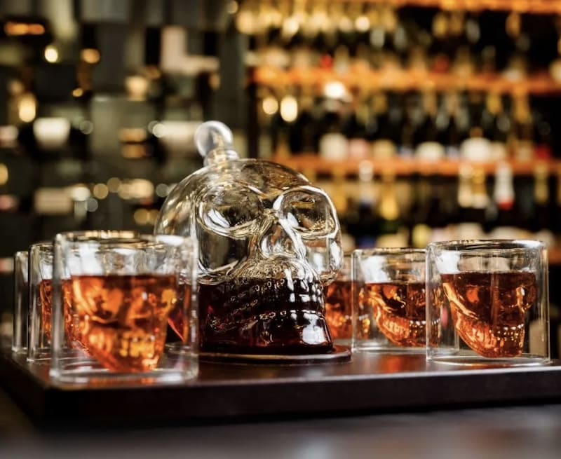 set of glasses and a whiskey decanter in the shape of a skull