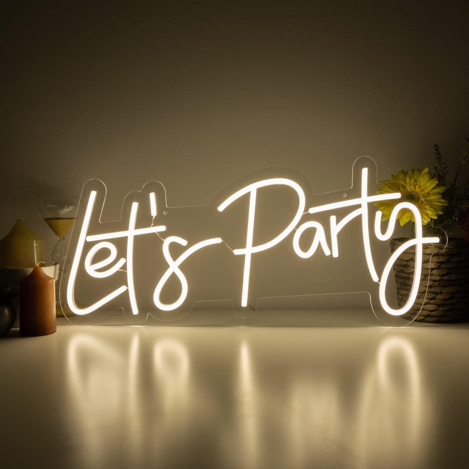 Lets party - illuminated LED neon sign hanging on the wall
